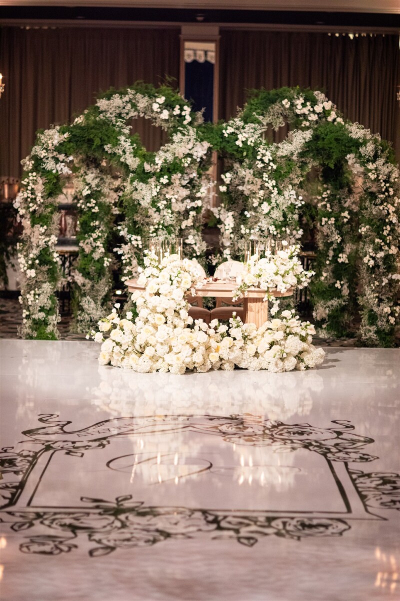 sweetheart table with white florals and greenery