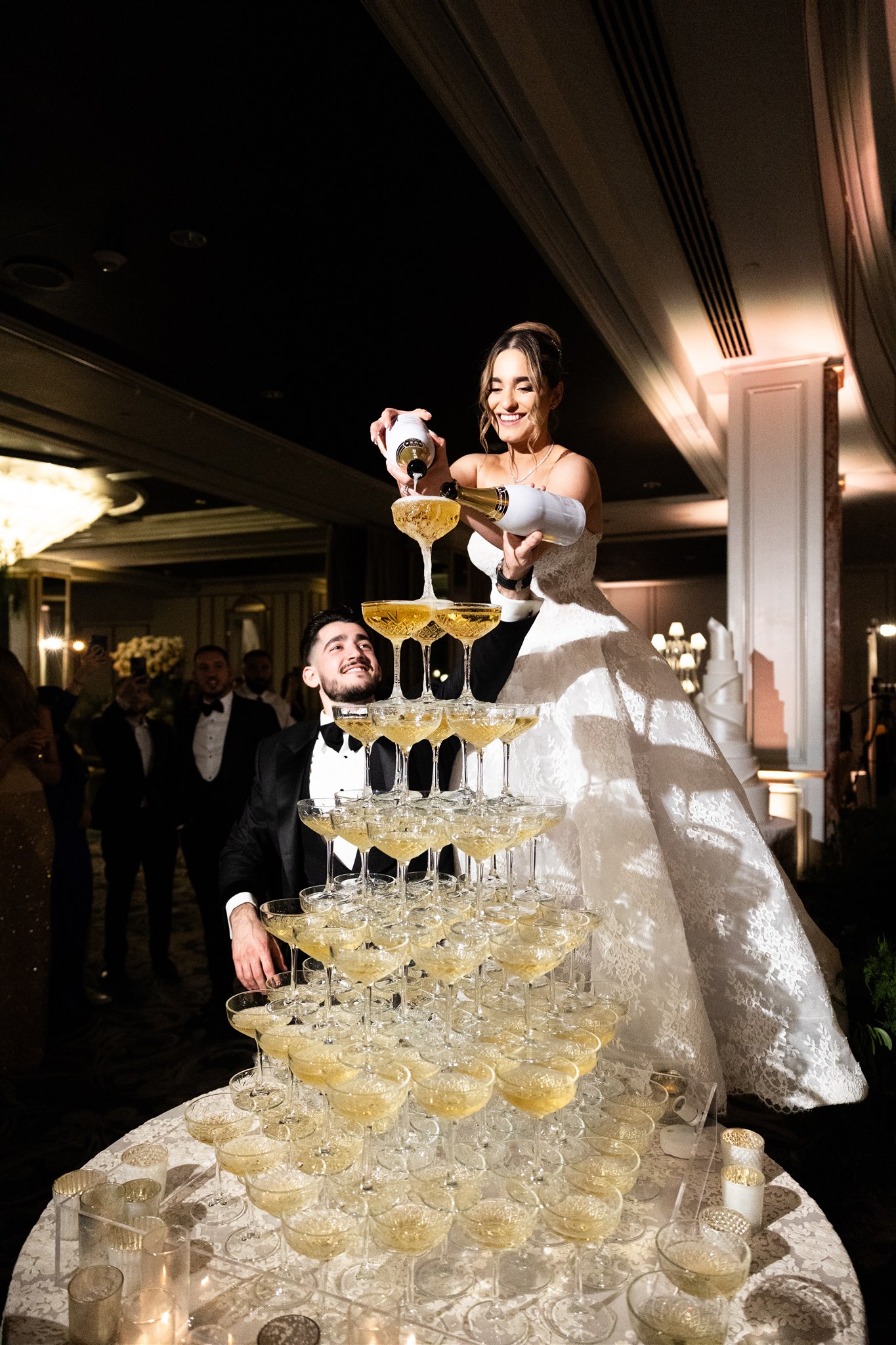 bride and groom with champagne tower