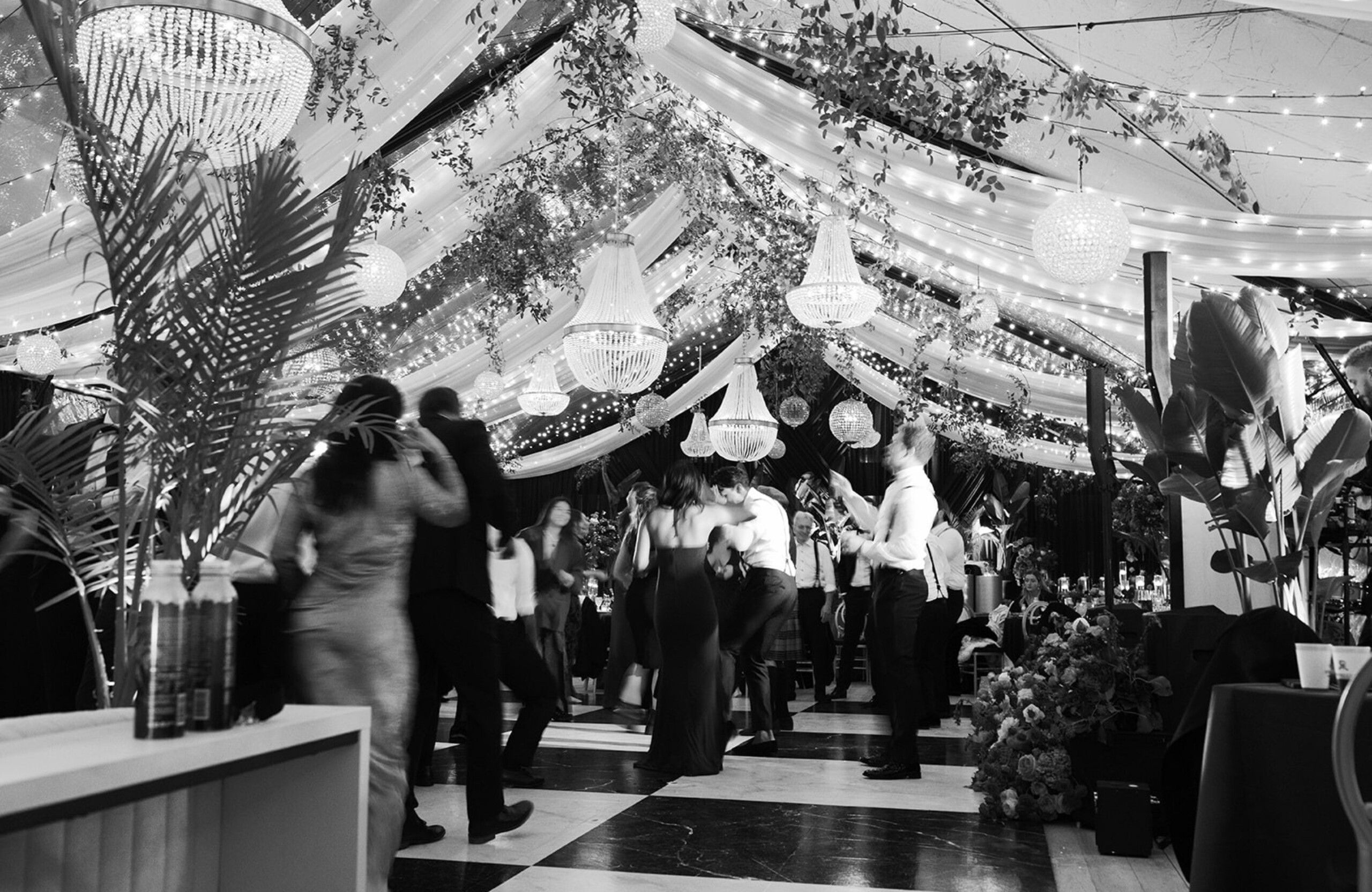 black and white photo of tented winter wedding reception