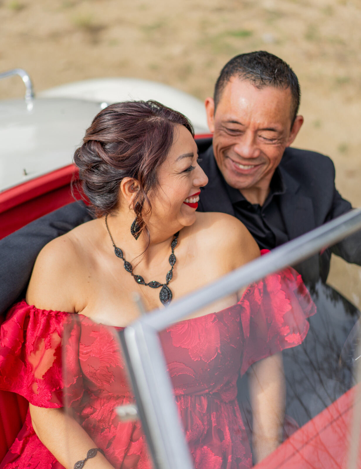 couple smiling in a classic car